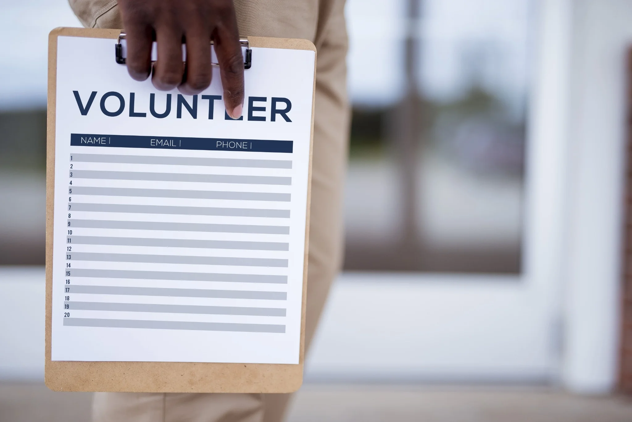closeup-shot-person-holding-volunteer-sign-up-sheet